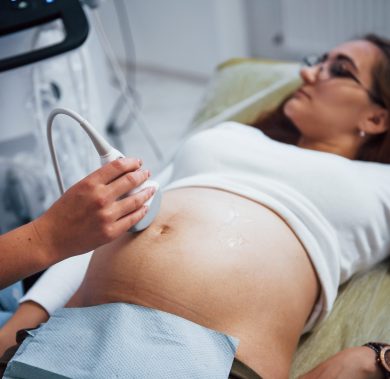 Female doctor does ultrasound for a pregnant woman in the hospital.