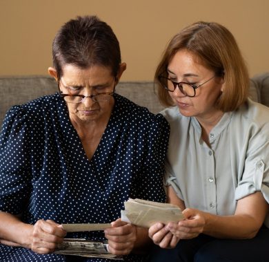 two-senior-women-watching-old-photos-2021-10-24-17-28-06-utc